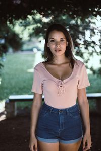 Portrait of teenage girl standing at park