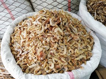 High angle view of dried prawns in sack