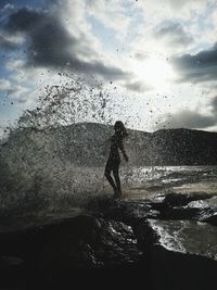 Shadow of man on sea shore against sky