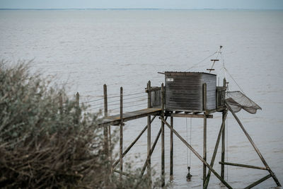 Lifeguard hut on beach against sky