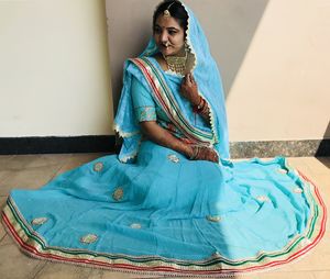 High angle view of woman wearing sari sitting at home