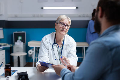 Female doctor examining patient in laboratory