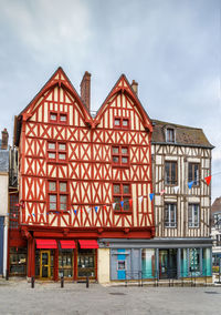 Building by street against sky