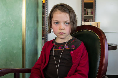 Portrait of cute girl standing at home