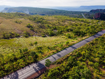 High angle view of road amidst trees against sky