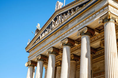 Low angle view of historical building against blue sky