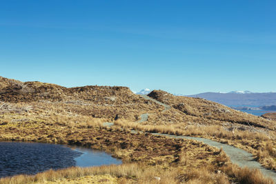 Scenic view of mountains against clear blue sky