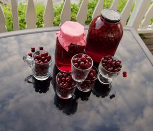 Close-up of fruits in glass container on table