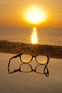 Close-up of water on beach during sunset