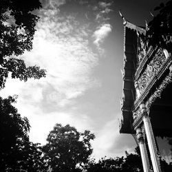 Low angle view of tower against cloudy sky