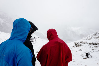 Rear view of man with snow against mountain