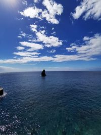 Scenic view of sea against blue sky