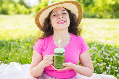 Portrait of a smiling young woman wearing hat