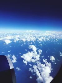 Cropped image of airplane flying over landscape