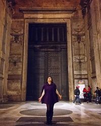 Full length of woman standing by railing