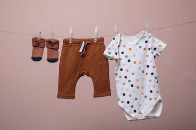 Close-up of clothes drying on clothesline against wall