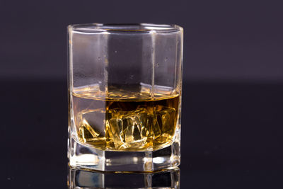 Close-up of beer glass against black background