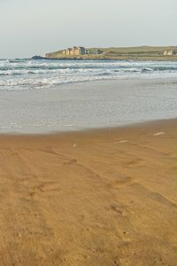 Scenic view of beach against clear sky