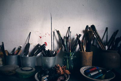 Multi colored pencils on table against wall