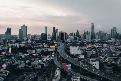 High angle view of modern buildings against sky during sunset