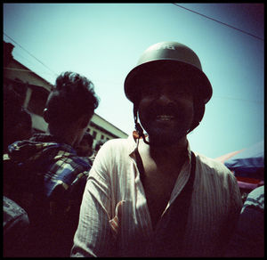 Portrait of young man wearing hat against sky