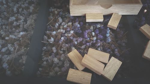 High angle view of various flowers on wooden table