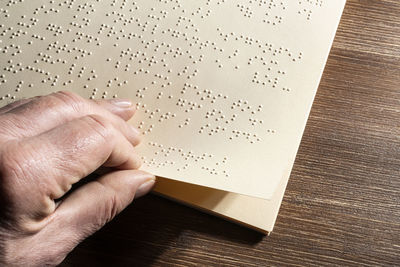 The page of a book written in braille alphabet, the tactile reading system in relief for the blind