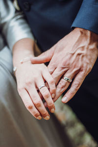 Midsection of couple holding hands