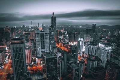 Illuminated cityscape against sky at night