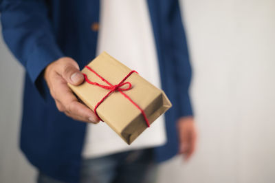 Close-up of human hand holding box