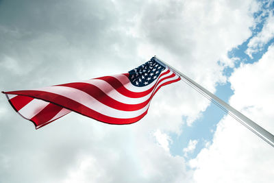 Low angle view of american flag against sky