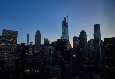 View of buildings in city of manhattan new york at dawn