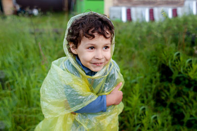 Boy wrapped in plastic while standing against land