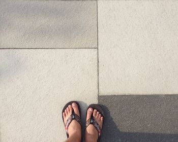 Low section of woman standing on tiled floor