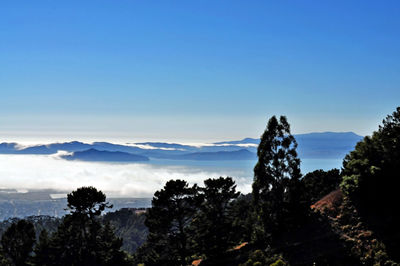 Scenic view of mountains against blue sky