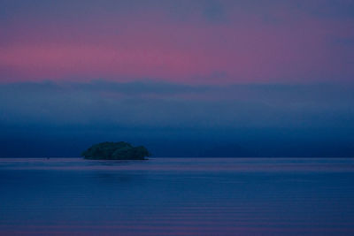 Scenic view of sea against sky at sunset