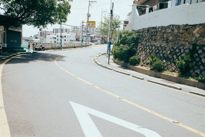 Road amidst trees in city