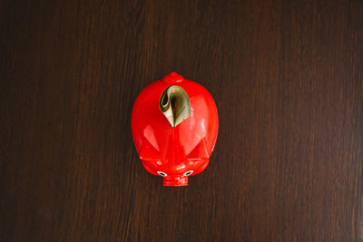 High angle view of red balloon on wooden table