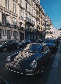 Cars parked on street by buildings in city