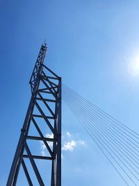 Low angle view of crane against blue sky