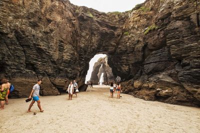 Group of people on rocks at beach