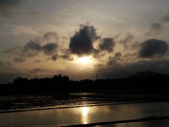 Scenic shot of calm lake at sunset