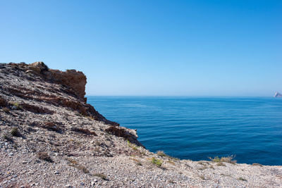 Scenic view of sea against clear blue sky