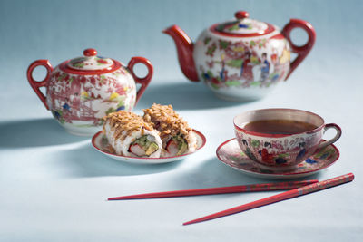 Japanese style tea party with vintage porcelain set, sweet rolls dessert for breakfast 