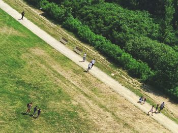 High angle view of people riding motorcycle on field