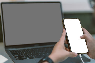 Midsection of man using mobile phone