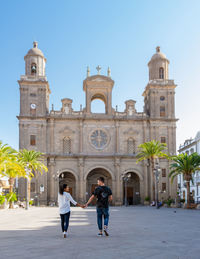 Rear view of people in front of cathedral