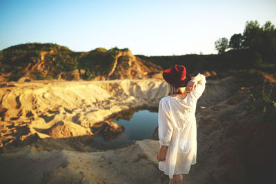 Rear view of woman against sky