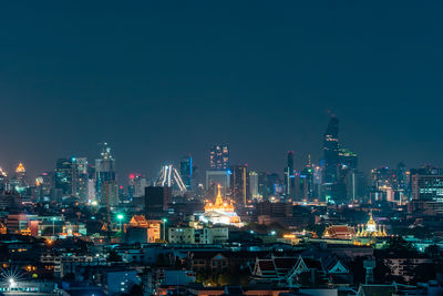 Illuminated buildings in city at night