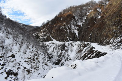 Scenic view of snow covered mountains against sky